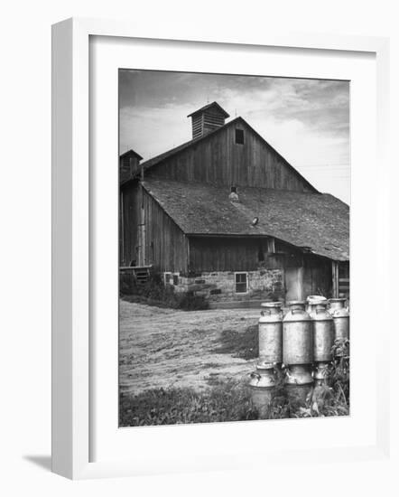 Milk Cans Being Stored on a Farm-null-Framed Photographic Print