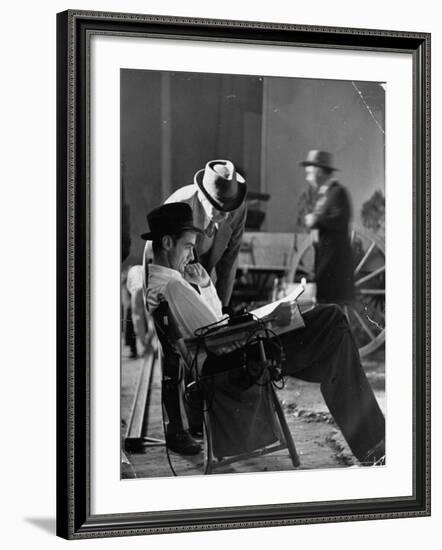 Millionaire Howard Hughes/Movie Studio Owner Studying Script on the Movie Set for "The Outlaw"-Bob Landry-Framed Premium Photographic Print