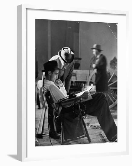 Millionaire Howard Hughes/Movie Studio Owner Studying Script on the Movie Set for "The Outlaw"-Bob Landry-Framed Premium Photographic Print