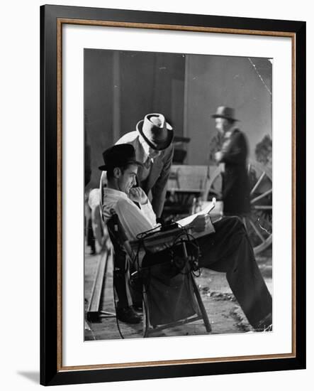 Millionaire Howard Hughes/Movie Studio Owner Studying Script on the Movie Set for "The Outlaw"-Bob Landry-Framed Premium Photographic Print