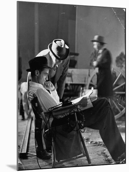 Millionaire Howard Hughes/Movie Studio Owner Studying Script on the Movie Set for "The Outlaw"-Bob Landry-Mounted Premium Photographic Print