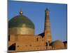 Minaret and Tiled Dome of a Mosque Rise Above the Old City of Khiva-Antonia Tozer-Mounted Photographic Print