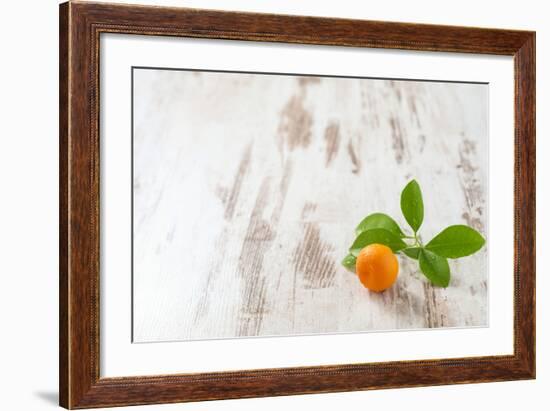 Mini-Orange with Foliage on White Wooden Table-Jana Ihle-Framed Photographic Print