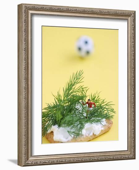 Miniature Footballer Fighting His Way Through Forest of Dill-Martina Schindler-Framed Photographic Print