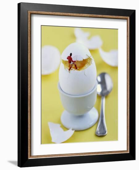 Miniature Footballer Taking the Lid off a Boiled Egg-Martina Schindler-Framed Photographic Print