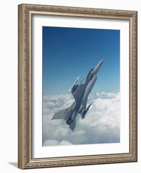 Missile-Armed Us F-16 Fighter Aircraft in Flight, Climbing Above Clouds-null-Framed Photographic Print