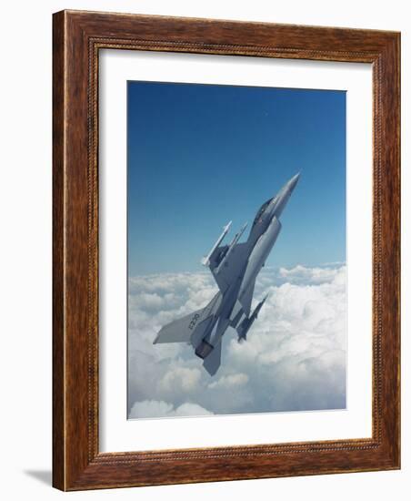 Missile-Armed Us F-16 Fighter Aircraft in Flight, Climbing Above Clouds-null-Framed Photographic Print