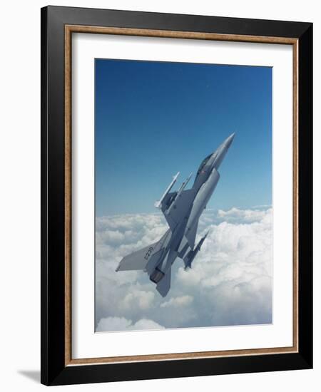 Missile-Armed Us F-16 Fighter Aircraft in Flight, Climbing Above Clouds-null-Framed Photographic Print