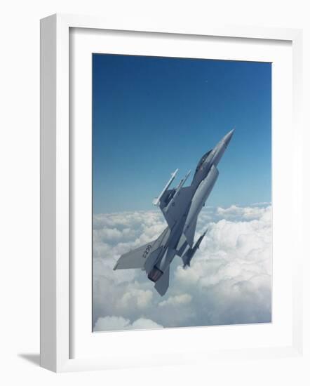 Missile-Armed Us F-16 Fighter Aircraft in Flight, Climbing Above Clouds-null-Framed Photographic Print