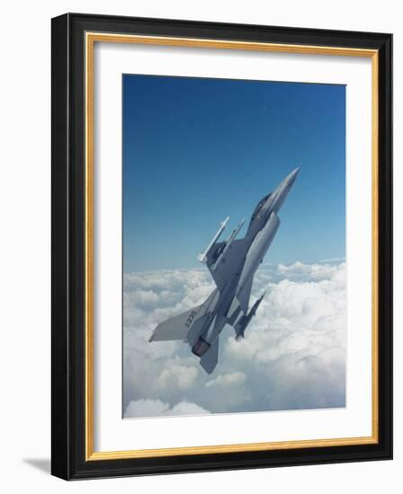 Missile-Armed Us F-16 Fighter Aircraft in Flight, Climbing Above Clouds-null-Framed Photographic Print