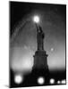 Misty Night Surrounding the Statue of Liberty with Fuzzy Balls of Light from Torch and Lampposts-Andreas Feininger-Mounted Photographic Print