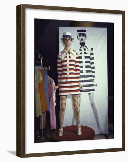 Model Dari Lallou Standing in Front of Poster of Twiggy Wearing Look a Like Outfit-Ralph Crane-Framed Premium Photographic Print