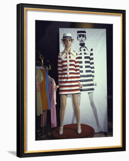 Model Dari Lallou Standing in Front of Poster of Twiggy Wearing Look a Like Outfit-Ralph Crane-Framed Premium Photographic Print