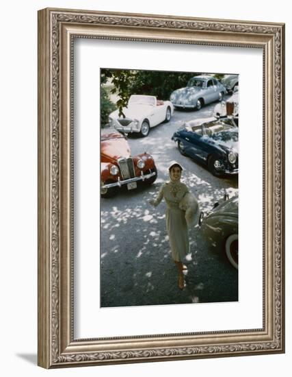 Model in a Dress and Gloves, a Fur over One Arm, and Surrounded by Vintage and Luxury Cars, 1954-Nina Leen-Framed Photographic Print