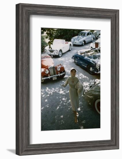 Model in a Dress and Gloves, a Fur over One Arm, and Surrounded by Vintage and Luxury Cars, 1954-Nina Leen-Framed Photographic Print