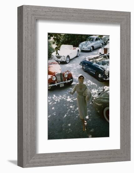 Model in a Dress and Gloves, a Fur over One Arm, and Surrounded by Vintage and Luxury Cars, 1954-Nina Leen-Framed Photographic Print