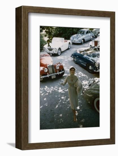 Model in a Dress and Gloves, a Fur over One Arm, and Surrounded by Vintage and Luxury Cars, 1954-Nina Leen-Framed Photographic Print