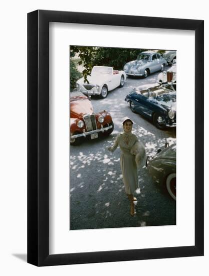 Model in a Dress and Gloves, a Fur over One Arm, and Surrounded by Vintage and Luxury Cars, 1954-Nina Leen-Framed Photographic Print