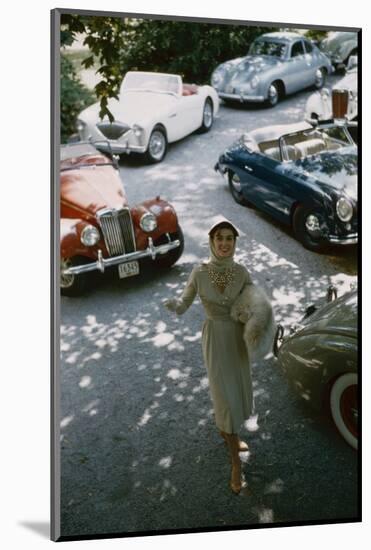 Model in a Dress and Gloves, a Fur over One Arm, and Surrounded by Vintage and Luxury Cars, 1954-Nina Leen-Mounted Photographic Print