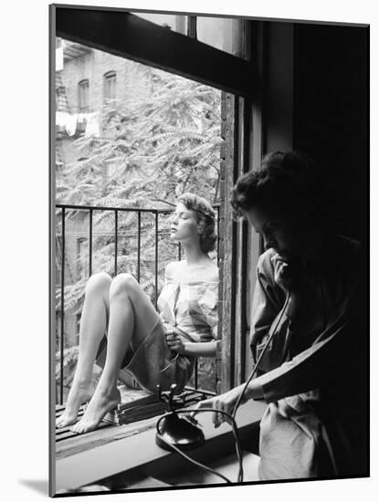 Model Jean Patchet Seated on a Fire Escape, Talks with Eileen Ford, New York, NY, 1948-Nina Leen-Mounted Photographic Print