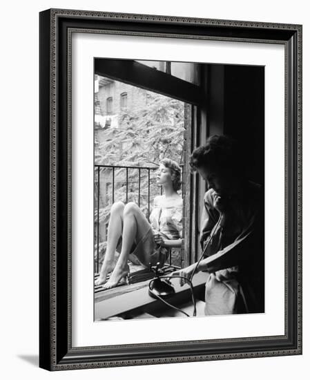 Model Jean Patchet Seated on a Fire Escape, Talks with Eileen Ford, New York, NY, 1948-Nina Leen-Framed Photographic Print