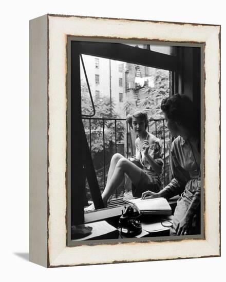 Model Jean Patchet Seated on a Fire Escape, Talks with Eileen Ford, New York, NY, 1948-Nina Leen-Framed Premier Image Canvas