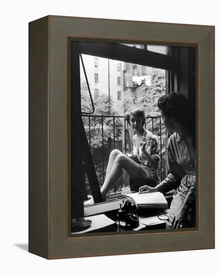 Model Jean Patchet Seated on a Fire Escape, Talks with Eileen Ford, New York, NY, 1948-Nina Leen-Framed Premier Image Canvas