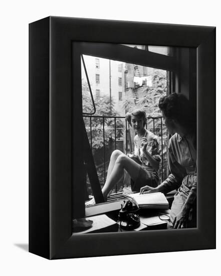 Model Jean Patchet Seated on a Fire Escape, Talks with Eileen Ford, New York, NY, 1948-Nina Leen-Framed Premier Image Canvas