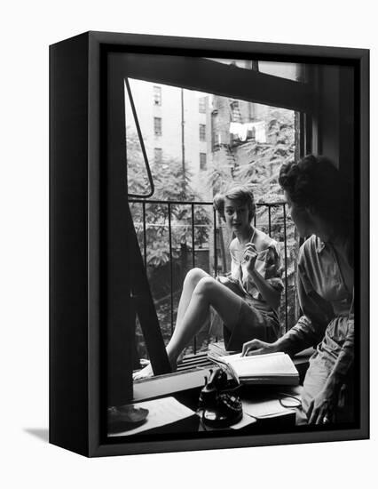 Model Jean Patchet Seated on a Fire Escape, Talks with Eileen Ford, New York, NY, 1948-Nina Leen-Framed Premier Image Canvas