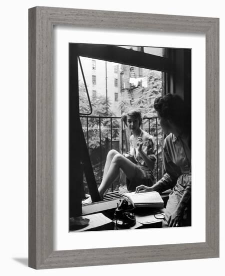 Model Jean Patchet Seated on a Fire Escape, Talks with Eileen Ford, New York, NY, 1948-Nina Leen-Framed Photographic Print