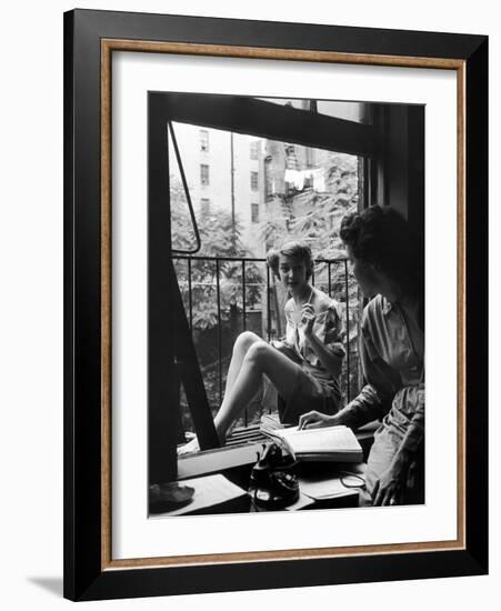 Model Jean Patchet Seated on a Fire Escape, Talks with Eileen Ford, New York, NY, 1948-Nina Leen-Framed Photographic Print