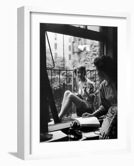 Model Jean Patchet Seated on a Fire Escape, Talks with Eileen Ford, New York, NY, 1948-Nina Leen-Framed Photographic Print