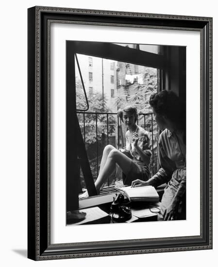 Model Jean Patchet Seated on a Fire Escape, Talks with Eileen Ford, New York, NY, 1948-Nina Leen-Framed Photographic Print