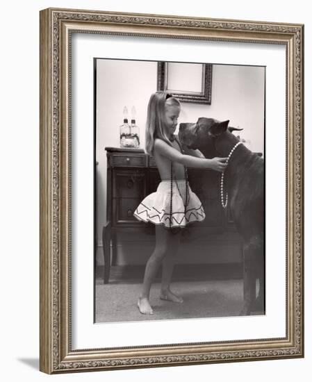 Model Posed Putting Costume Jewelry on Great Dane, Children's Fall Fashion-Nina Leen-Framed Photographic Print