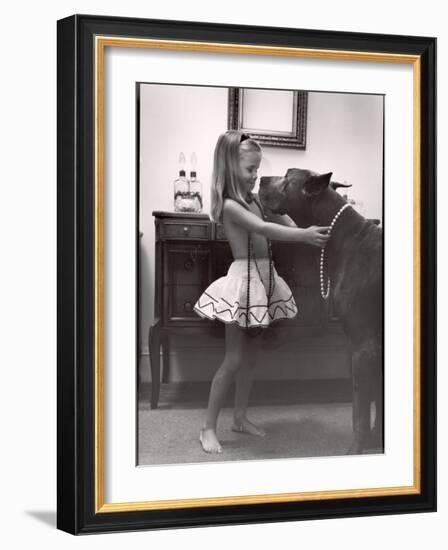 Model Posed Putting Costume Jewelry on Great Dane, Children's Fall Fashion-Nina Leen-Framed Photographic Print