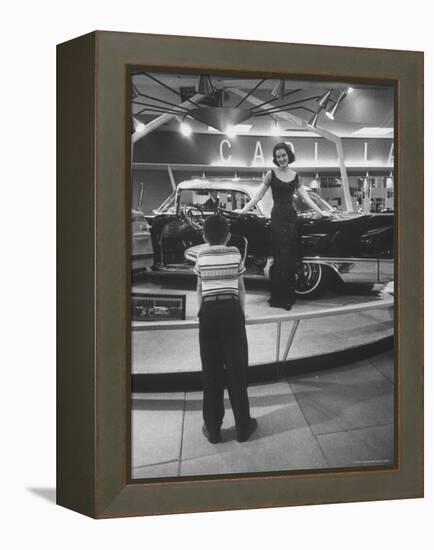 Model Posing Beside Cadillac Eldorado Captures Attention of Young Boy at National Automobile Show-Walter Sanders-Framed Premier Image Canvas