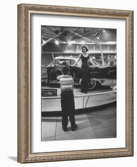 Model Posing Beside Cadillac Eldorado Captures Attention of Young Boy at National Automobile Show-Walter Sanders-Framed Photographic Print