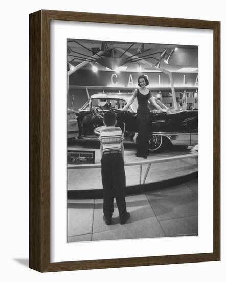 Model Posing Beside Cadillac Eldorado Captures Attention of Young Boy at National Automobile Show-Walter Sanders-Framed Photographic Print