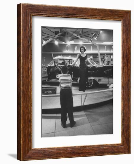 Model Posing Beside Cadillac Eldorado Captures Attention of Young Boy at National Automobile Show-Walter Sanders-Framed Photographic Print