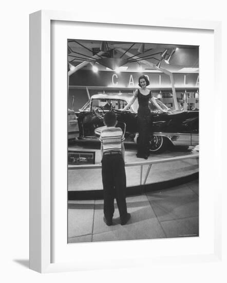 Model Posing Beside Cadillac Eldorado Captures Attention of Young Boy at National Automobile Show-Walter Sanders-Framed Photographic Print