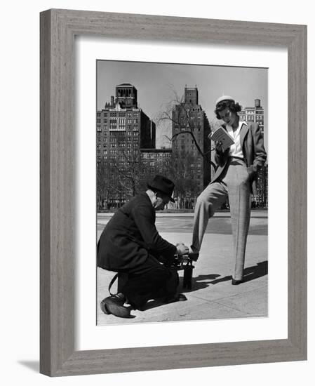 Model Showing Off Slacks as She Reads a First Aid Text Book in Washington Square Park-Nina Leen-Framed Photographic Print