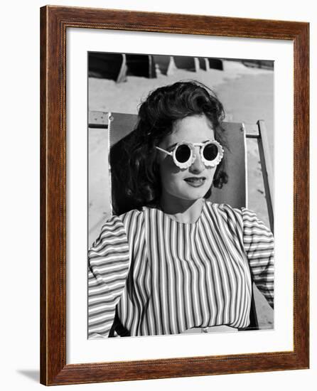 Model Stephanie Nikashian Sporting Sunglasses with "Seashell Rims" While Lounging at Beach-Alfred Eisenstaedt-Framed Photographic Print