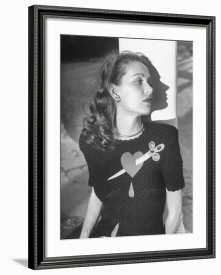 Model Wearing Sweater with Heart Pierced by Jeweled Dagger-Nina Leen-Framed Photographic Print