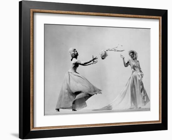 Model Wearing Wedding Gown Tossing Bouquet to Another Model Dresses as Bridesmaid-Gjon Mili-Framed Photographic Print
