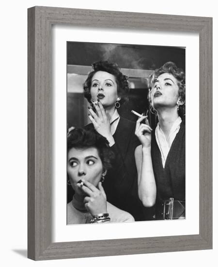 Models Exhaling Elegantly, Learning Proper Cigarette Smoking Technique in Practice For TV Ad-Peter Stackpole-Framed Photographic Print