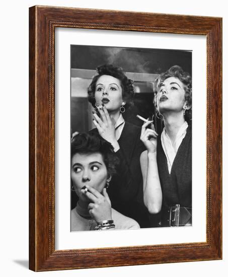 Models Exhaling Elegantly, Learning Proper Cigarette Smoking Technique in Practice For TV Ad-Peter Stackpole-Framed Photographic Print