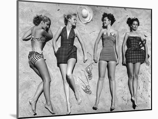 Models Lying on Beach to Display Bathing Suits-Nina Leen-Mounted Photographic Print