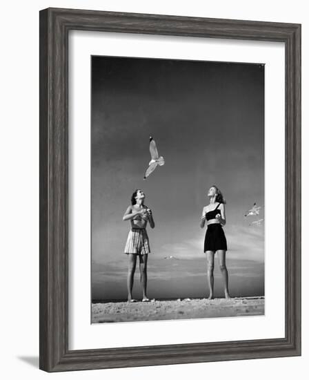 Models Tee Matthews and Bobbie Chambliss Feeding Gulls While Modeling New Bathing Suit Styles-Alfred Eisenstaedt-Framed Photographic Print