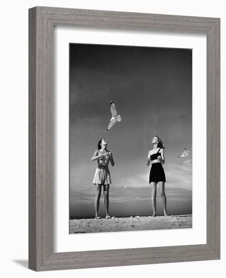 Models Tee Matthews and Bobbie Chambliss Feeding Gulls While Modeling New Bathing Suit Styles-Alfred Eisenstaedt-Framed Photographic Print