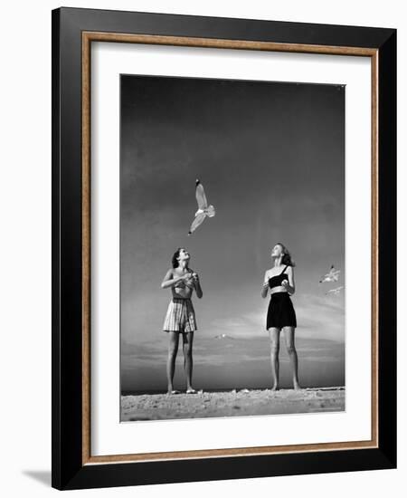 Models Tee Matthews and Bobbie Chambliss Feeding Gulls While Modeling New Bathing Suit Styles-Alfred Eisenstaedt-Framed Photographic Print